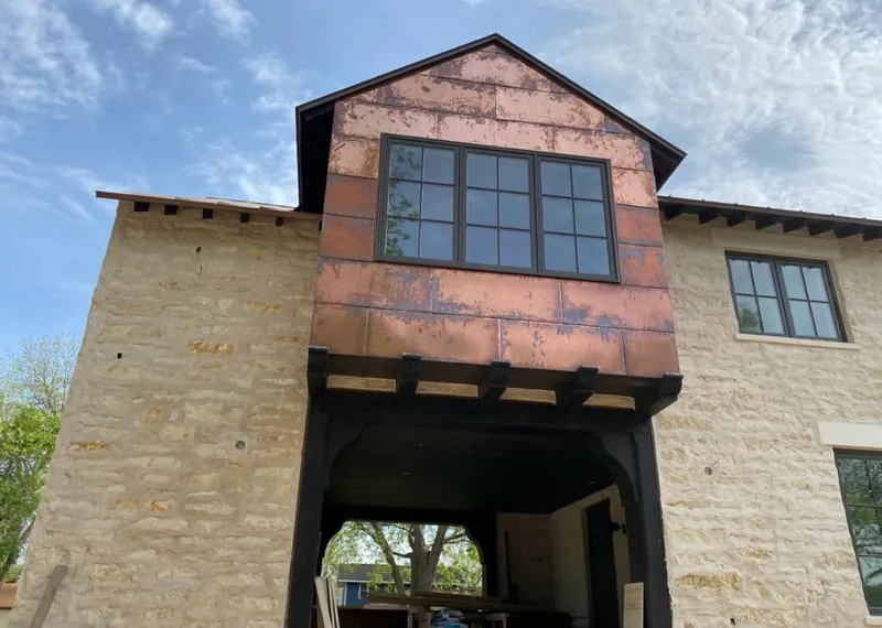 Copper metal panel facade on a stone building for Skylight Installation in Hood River
